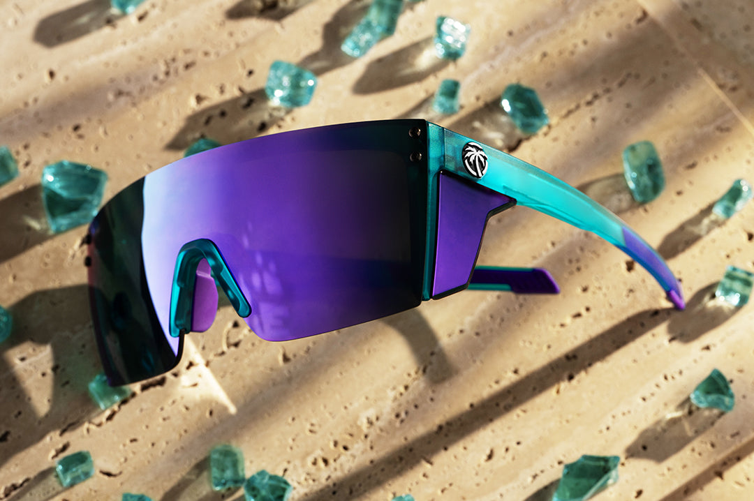 Heat Wave Performance Lazer sunglasses with purple lenses and aqua frame pictured with broken glass