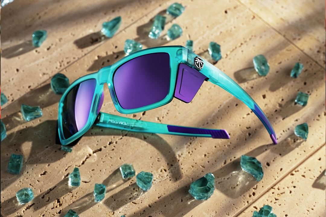 Heat Wave Performance Vise sunglasses with purple lenses and aqua frame pictured with broken glass