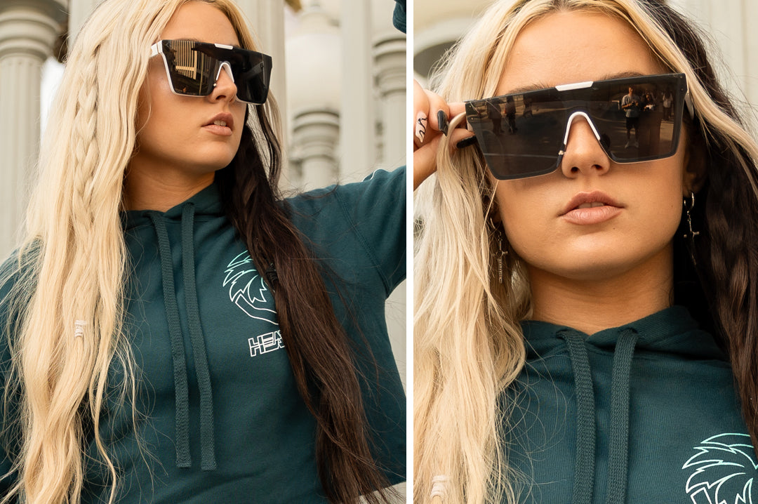 Women wearing the Heat Wave Visual Clarity Sunglasses with white frame and black lens.