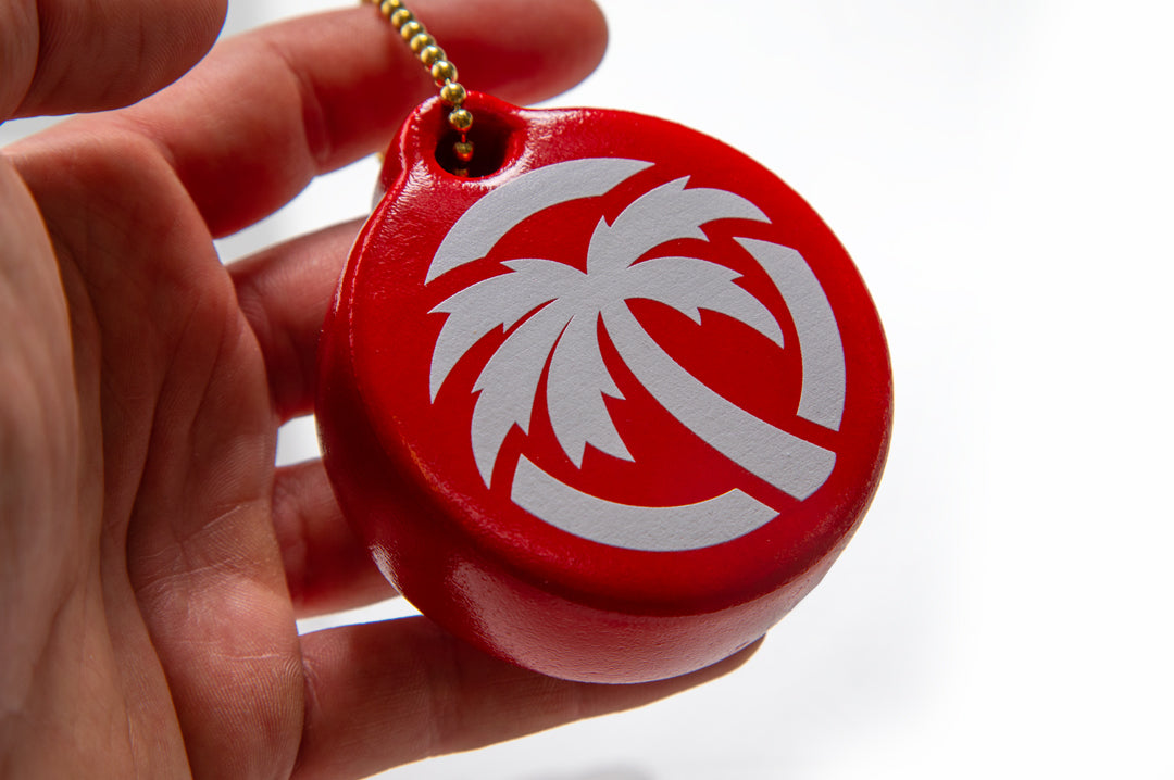 Heat Wave Visual Palm Icon red floaty keychain held in hands.