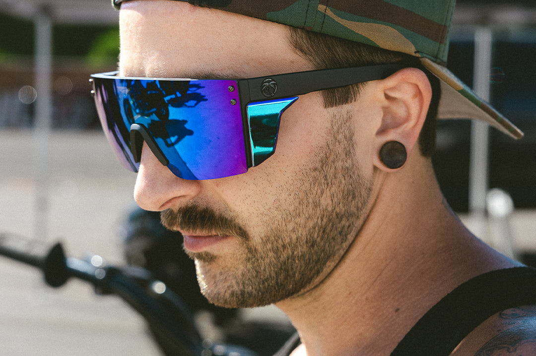 Biker rocking the Heat Wave Visual Performance Lazer Face Sunglasses with black frame, piff green blue lens and matching colored side shields.