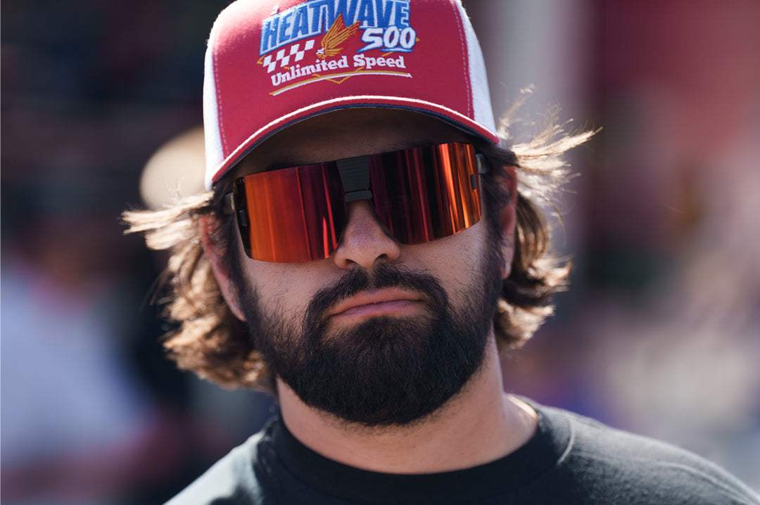 Esmarco rocking the Heat Wave Visual Vector Sunglasses with black frame and sunblast orange yellow lens.