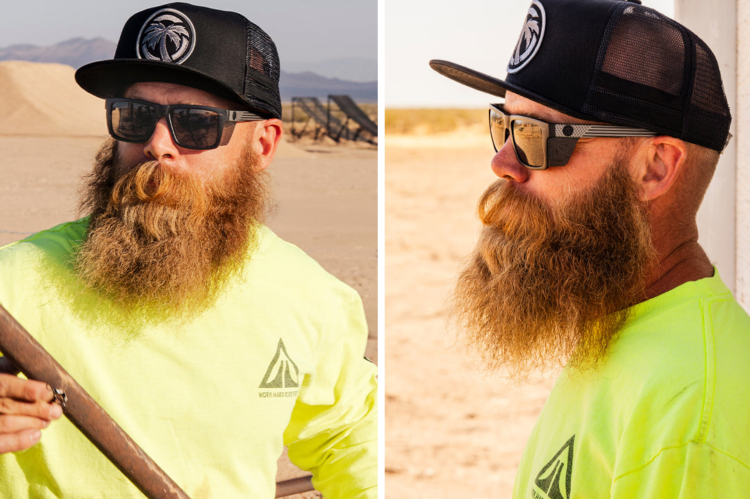 Bearded man wearing Heat Wave Performance Vise black safety sunglasses with Socom USA Flag arms and matching black Socom hat.