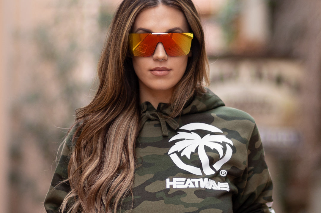 Young Women wearing Heat Wave Visual Quatro Sunglasses with black frame and sunblast orange yellow lens.