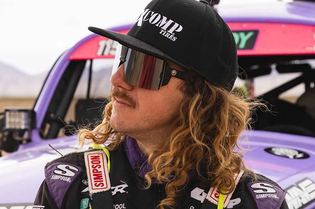 Black Wilkey wearing Heat Wave Visual Vector Sunglasses with black frame and silver lens.